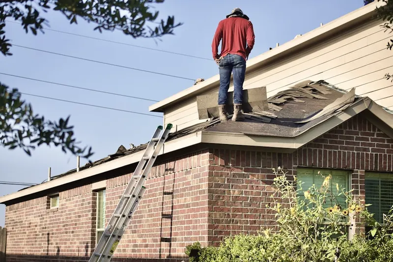 Professional roofer working on a residential roof in Lou-vre Estates